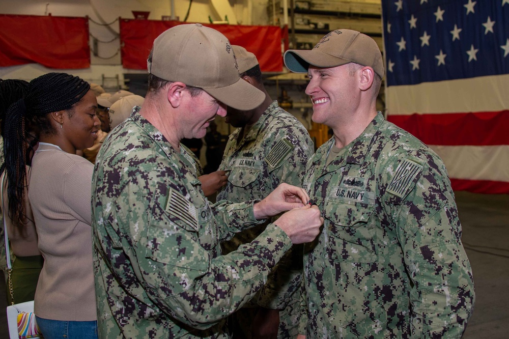 Boxer Promotes 128 Sailors in Ceremony