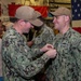 Boxer Promotes 128 Sailors in Ceremony