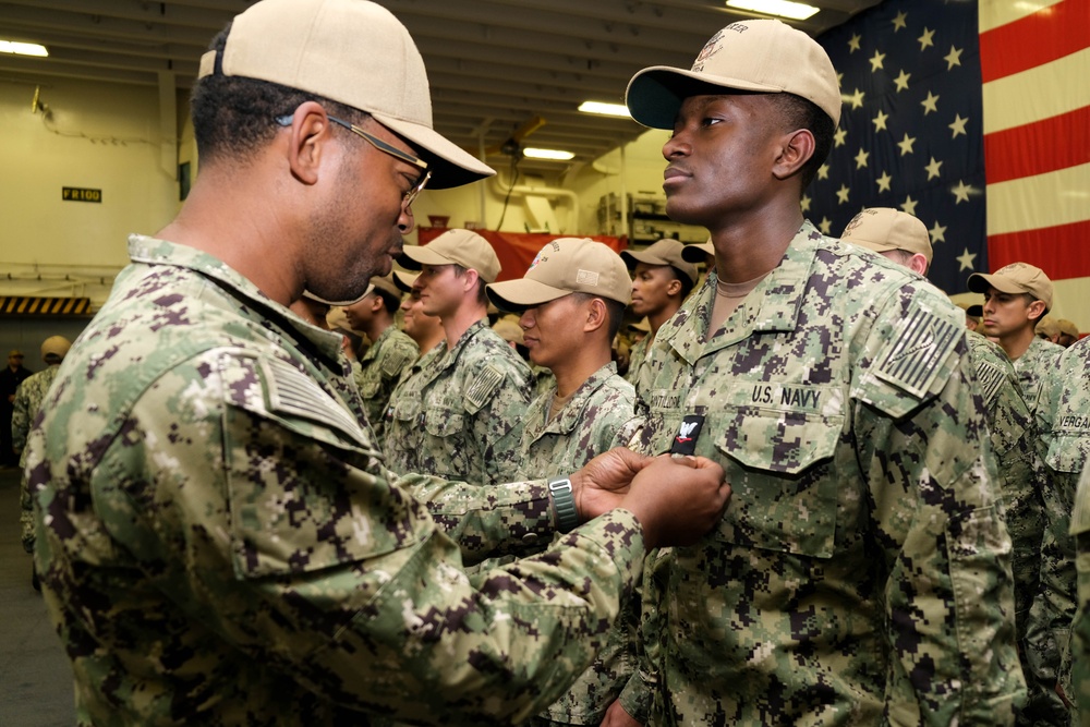 Boxer Promotes 128 Sailors in Ceremony