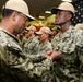 Boxer Promotes 128 Sailors in Ceremony