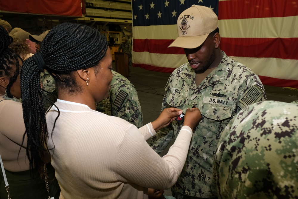 Boxer Promotes 128 Sailors in Ceremony