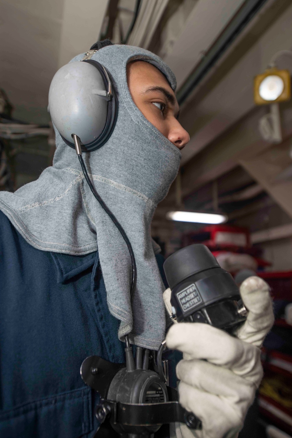 USS Theodore Roosevelt (CVN 71) Sailor perform a sprinkler check.