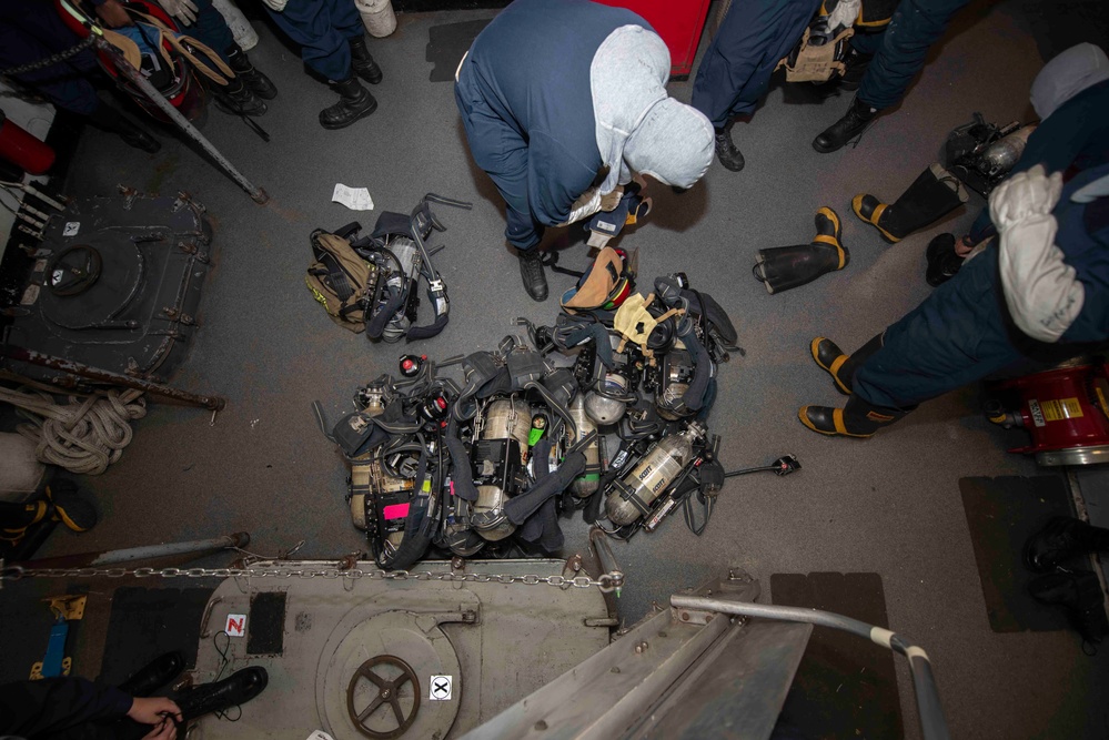 USS Theodore Roosevelt (CVN 71) Sailor perform a sprinkler check.