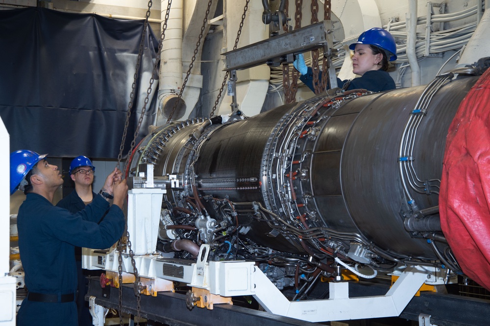 USS Ronald Reagan (CVN 76) Sailors move a jet engine