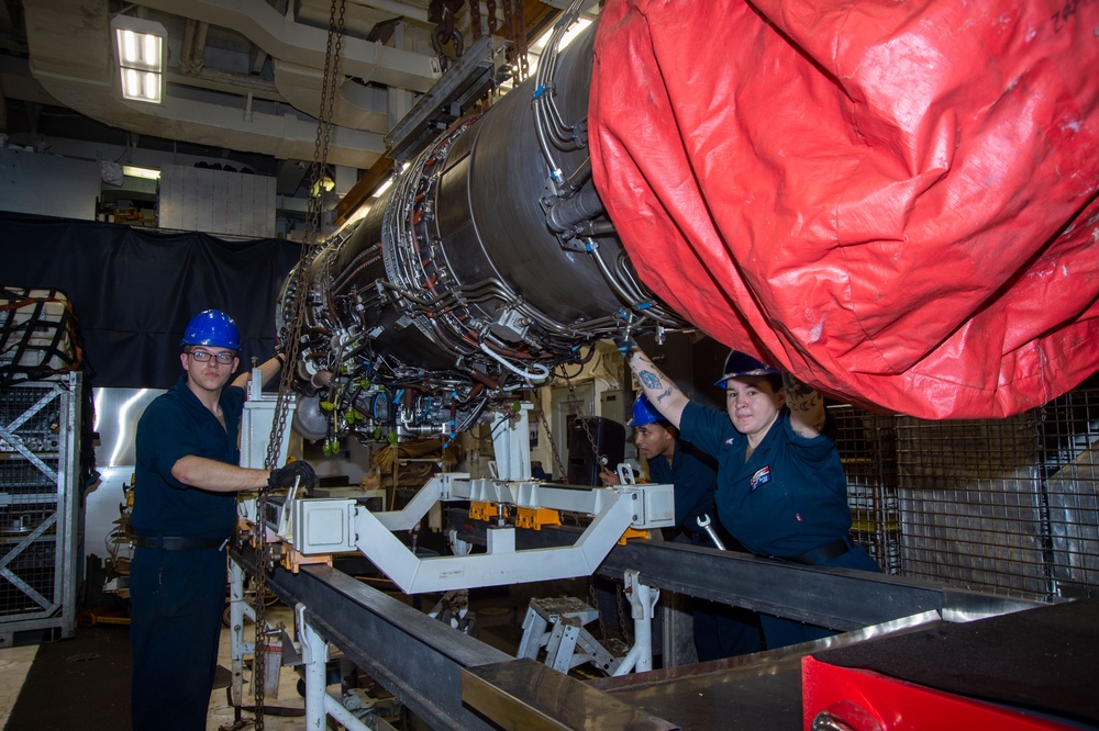 USS Ronald Reagan (CVN 76) Sailors move a jet engine