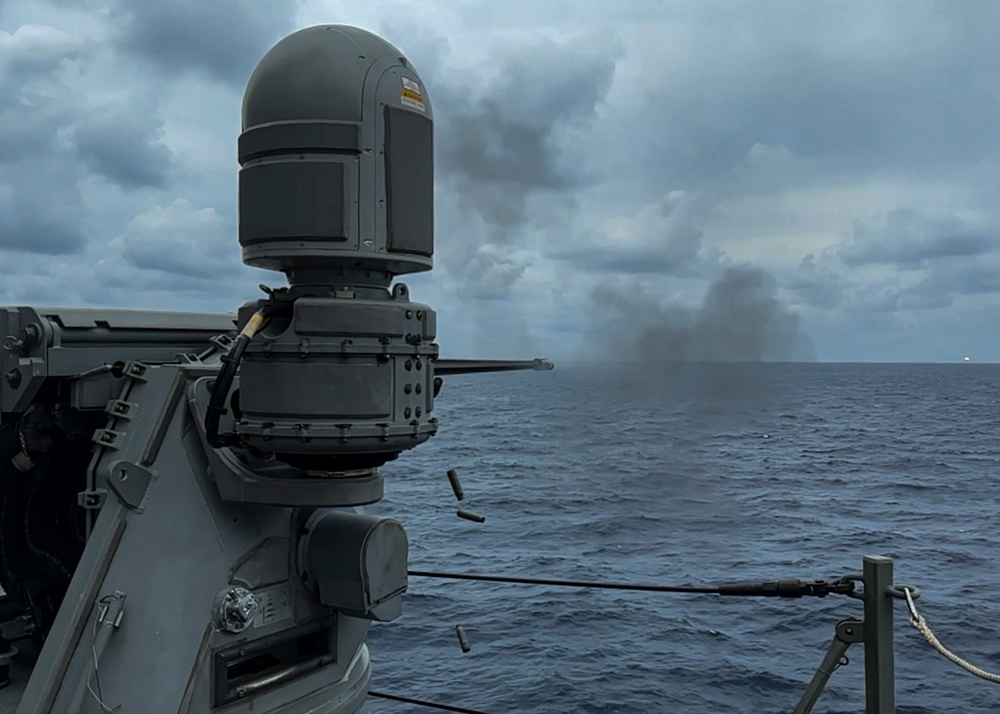 USS Rafael Peralta (DDG 115) fires a Mk 38 25mm machine gun during a live fire exercise