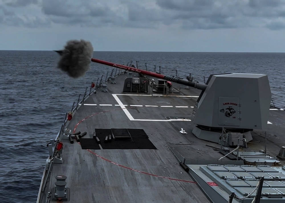 USS Rafael Peralta (DDG 115) fires a Mark 45 5-inch gun during a live fire exercise