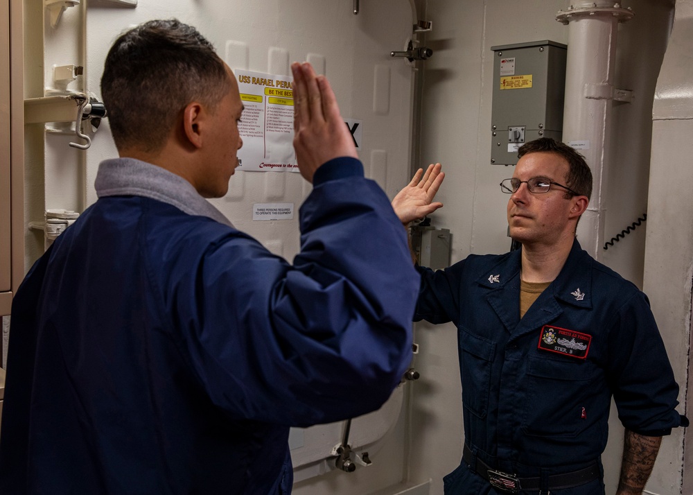 USS Rafael Peralta (DDG 115) conducts a reenlistment on the messdecks