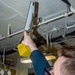 USS Ronald Reagan (CVN 76) Sailor stands steering gear room watch