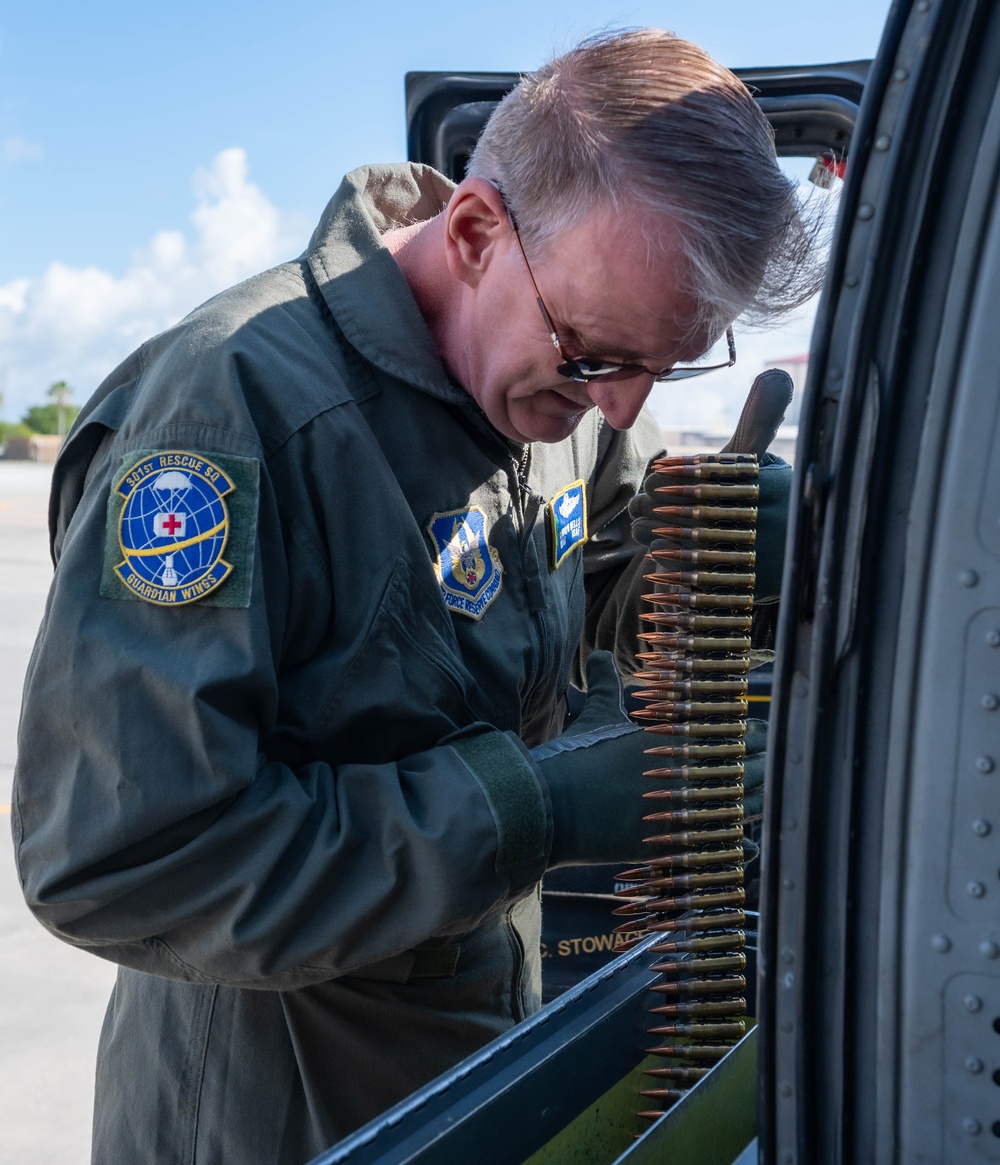 Loading ammo on an HH-60G Pave Hawk helicopter