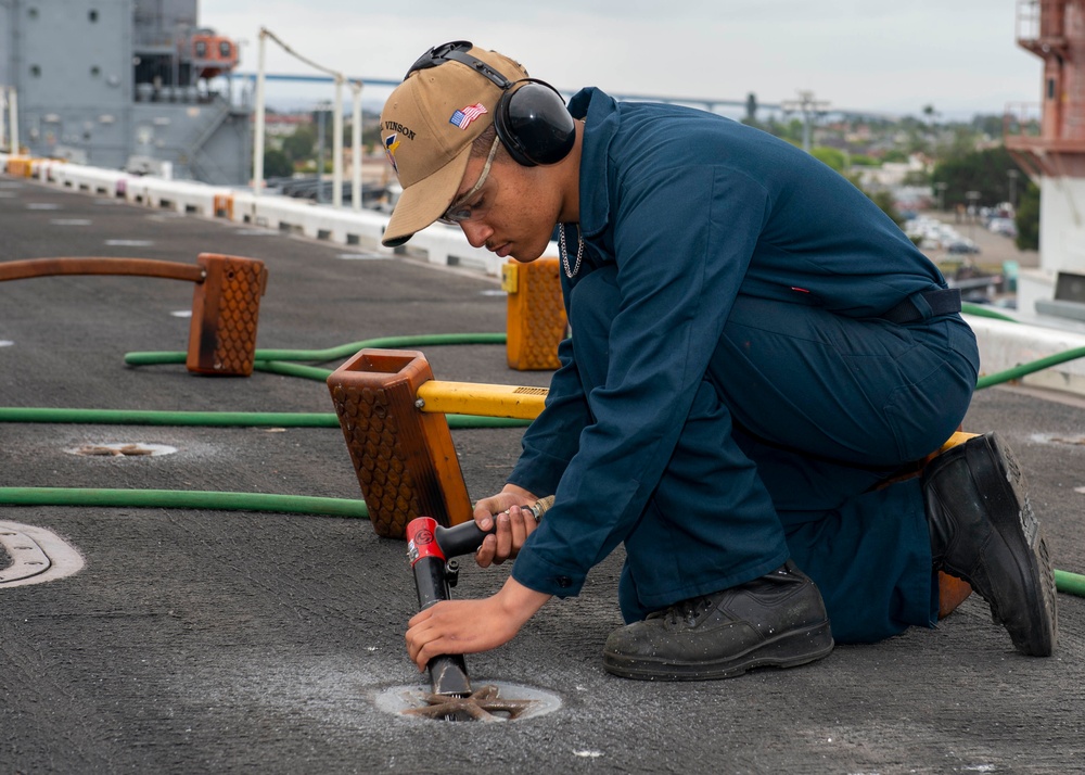 Sailor refurbishes pad-eyes aboard USS Carl Vinson (CVN 70)