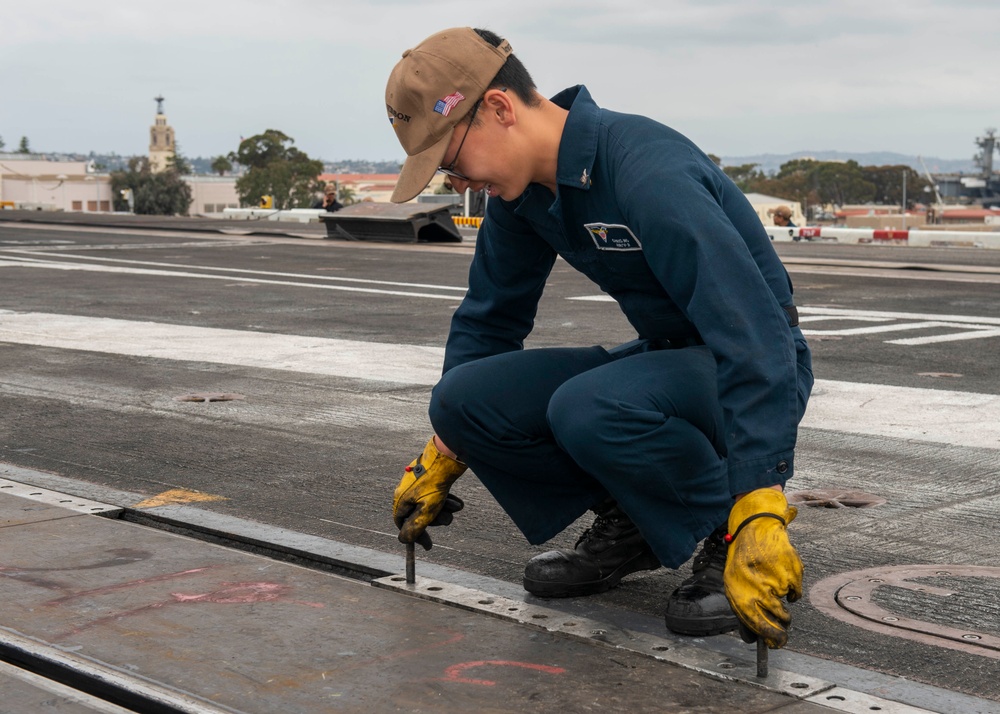 Sailor preforms maintenance the flight deck aboard USS Carl Vinson (CVN 70)