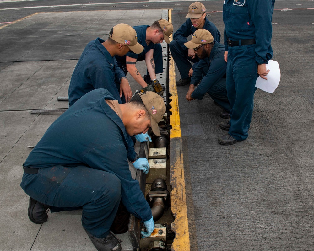 Sailors preform maintenance on the flight deck aboard USS Carl Vinson (CVN 70)