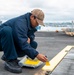 Sailor Paints Flight Deck aboard USS Carl Vinson