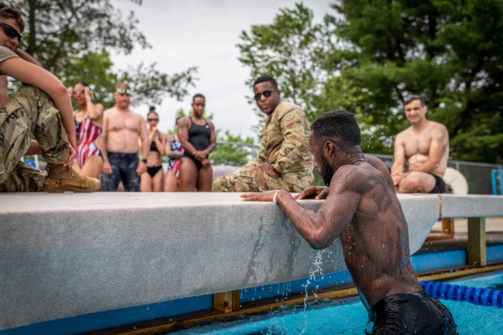 Army Reserve Sgt. Asuerus Thompson climbs an obstacle