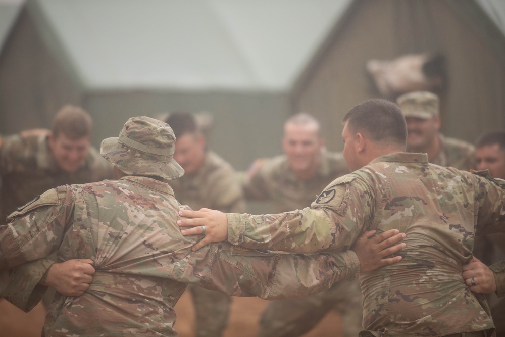 145th Field Artillery Soldiers dance in the Moroccan rain