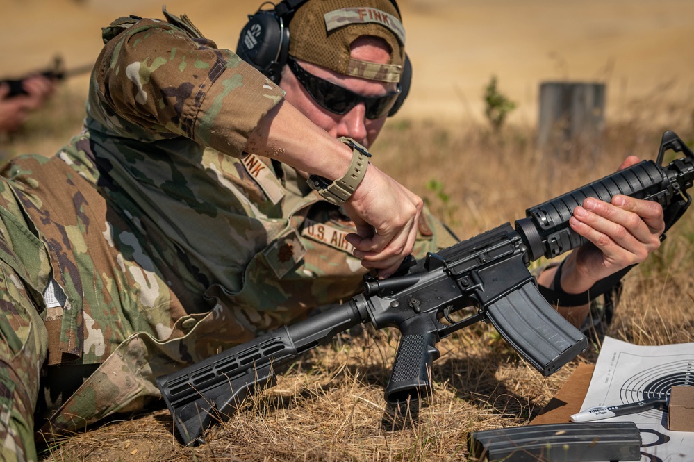 Air Force Reserve Maj. James Fink adjusts sights