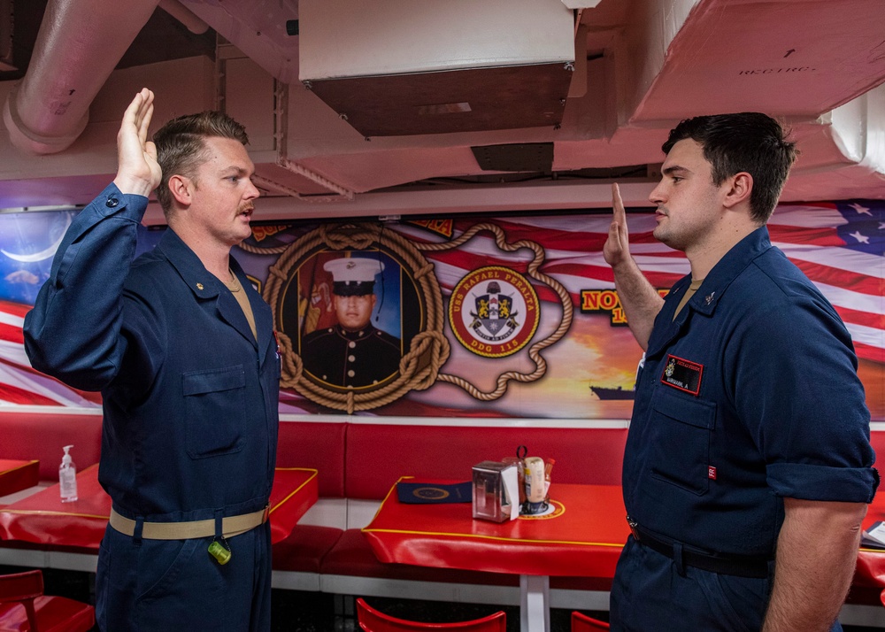 USS Rafael Peralta (DDG 115) conducts a reenlistment on the messdecks