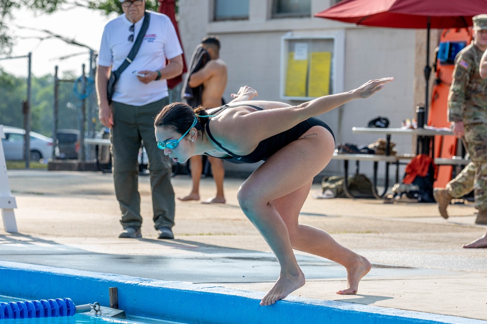 Army Reserve 1st Lt. Brianna Mirmina dives into a pool