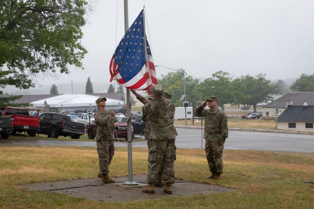 A Michigan National Guard flag detail brings down the Nation's flag at the TAG Social