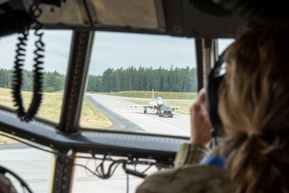 U.S. Airmen, 152nd Airlift Wing and 153rd Airlift Wing, complete a C-130 Hercules cargo drop