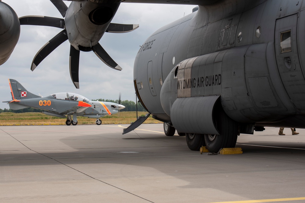 U.S. Airmen, 152nd Airlift Wing and 153rd Airlift Wing, complete a C-130 Hercules cargo drop.