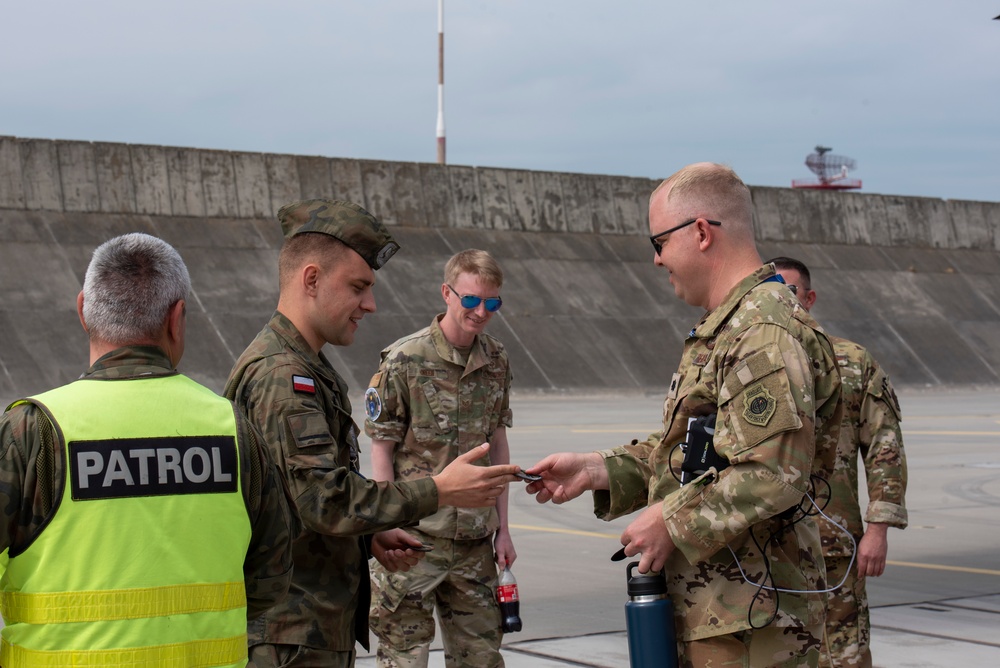 U.S. Airmen, 152nd Airlift Wing and 153rd Airlift Wing, complete a C-130 Hercules cargo drop.