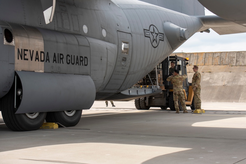 U.S. Airmen, 152nd Airlift Wing and 153rd Airlift Wing, complete a C-130 Hercules cargo drop