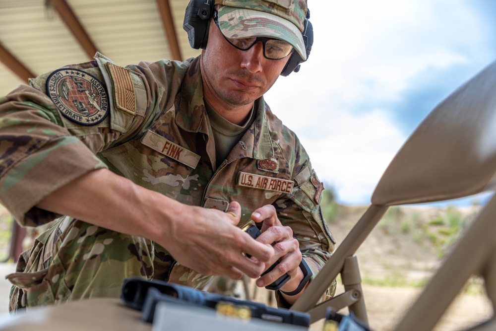 Air Force Reserve Maj. James Fink loads pistol magazines