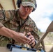 Air Force Reserve Maj. James Fink loads pistol magazines