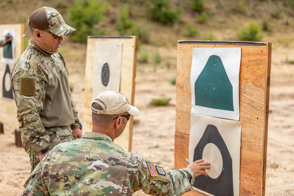 Air Force Reserve Col. Ryan “MZ” Montanez receives pistol training