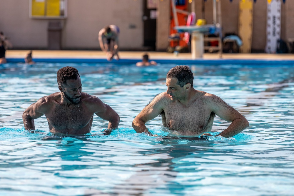 Army Reserve Sgt. Asuerus Thompson receives swimming tips