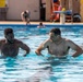 Army Reserve Sgt. Asuerus Thompson receives swimming tips