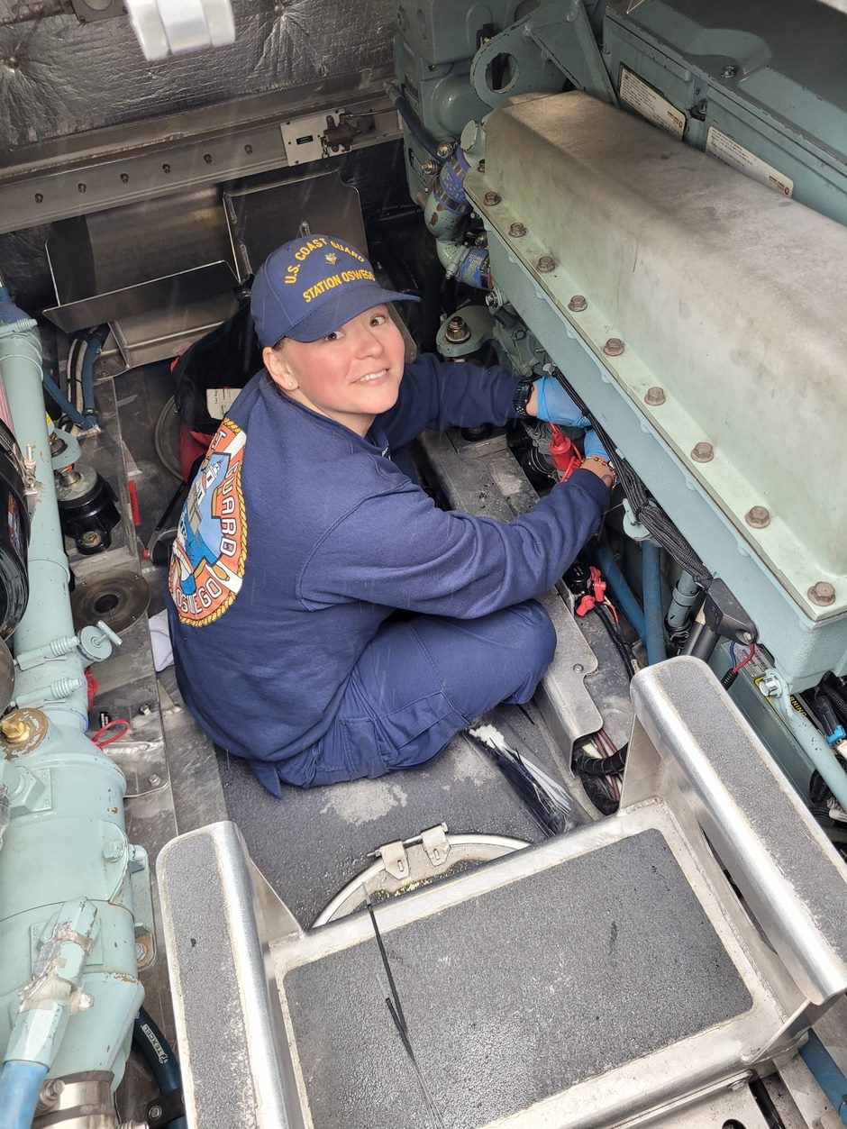 Coast Guard Station Oswego member performs maintenance on response boat