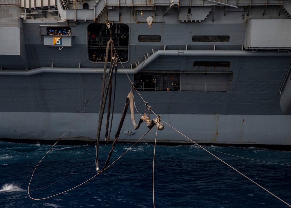 USS Rafael Peralta (DDG 115) conducts a replenishment-at-sea with the Nimitz-class nuclear-powered aircraft carrier USS Ronald Reagan (CVN 76)