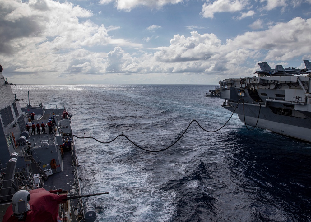 USS Rafael Peralta (DDG 115) conducts a replenishment-at-sea with the Nimitz-class nuclear-powered aircraft carrier USS Ronald Reagan (CVN 76)