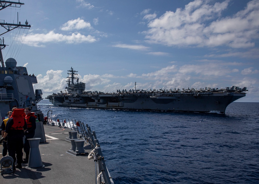 USS Rafael Peralta (DDG 115) conducts a replenishment-at-sea with the Nimitz-class nuclear-powered aircraft carrier USS Ronald Reagan (CVN 76)