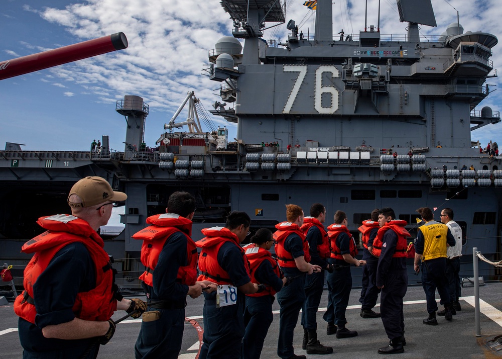 USS Rafael Peralta (DDG 115) conducts a replenishment-at-sea with the Nimitz-class nuclear-powered aircraft carrier USS Ronald Reagan (CVN 76)