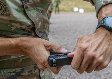 Army Reserve 1st Lt. Joshua Moeller clears his Glock