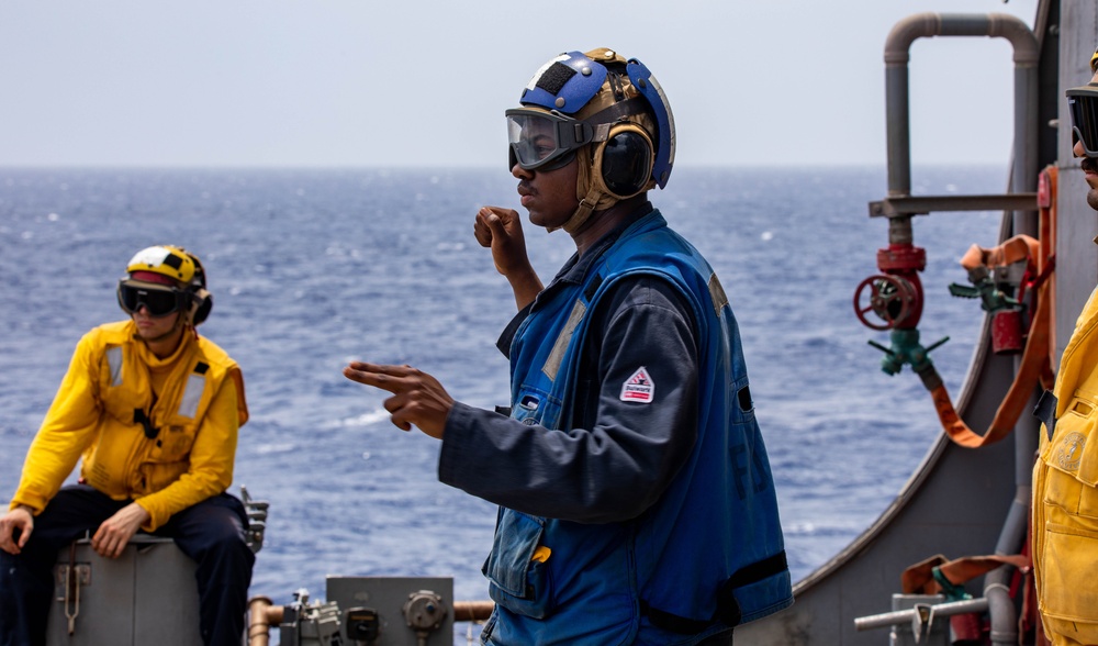 USS Robert Smalls (CG 62) Sailor Signals During Flight Quarters