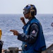 USS Robert Smalls (CG 62) Sailor Signals During Flight Quarters