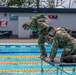 U.S. Army Reserve CIOR competitors complete a swim obstacle