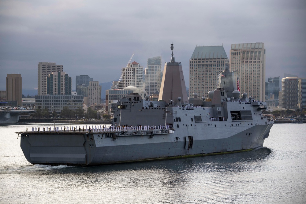 Sailors render honors to USS Anchorage as it returns to home port