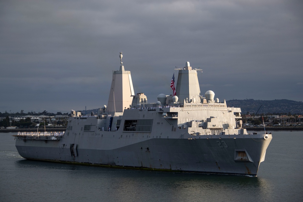 Sailors render honors to USS Anchorage as it returns to home port