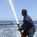 Sailor Demonstrates Hose Use