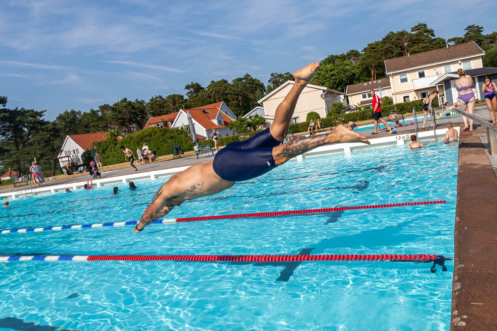 Army Reserve Staff Sgt. Devin Crawford dives into a pool