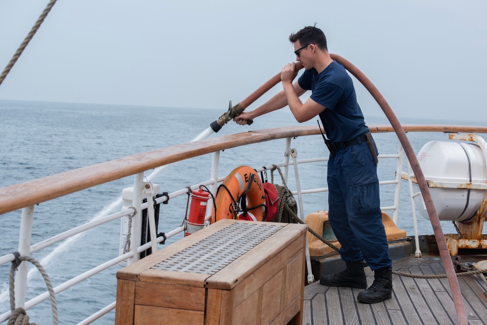 USCGC Eagle's crew maintains equipment underway