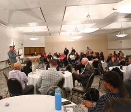 Capt. Cory Schemm addresses supervisors during opening remarks at command offsite.