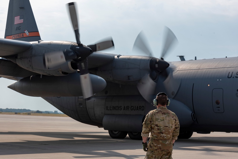 U.S. Airman prepares for a flight on a C-130 Hercules aircraft at exercise Air Defender 2023
