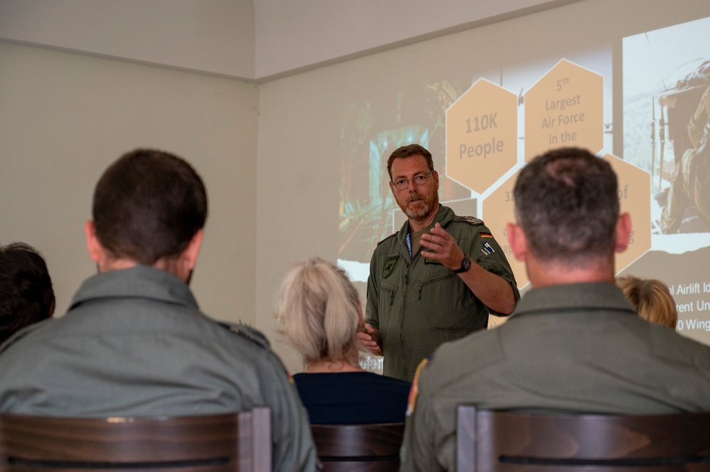 German air force Col. Christian John speaks to a group of local politicians and citizens during exercise Air Defender 2023
